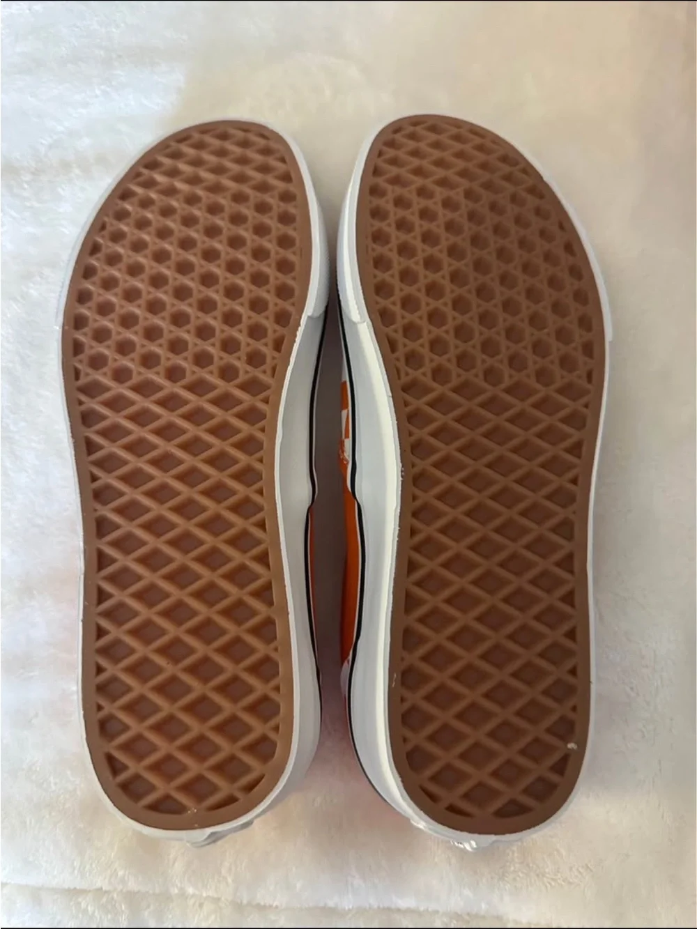 Orange and white checkerboard slip on vans